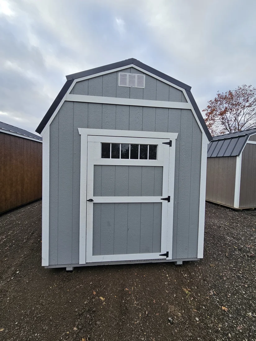 Gray lofted shed with white trim and front double doors
