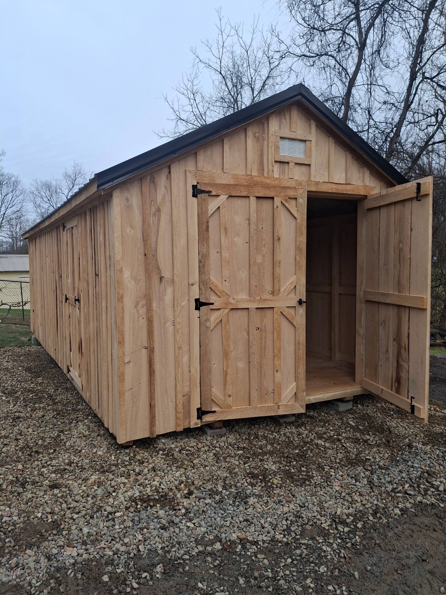 Wilmington natural wood shed with dark metal roof